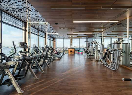 A gym with treadmills, elliptical machines and other cardio equipment.