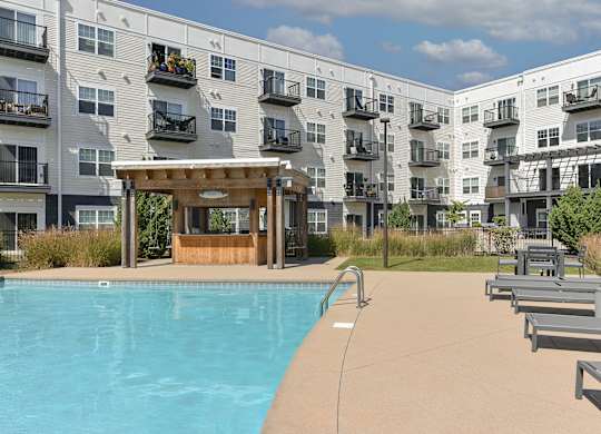 a swimming pool in front of an apartment building