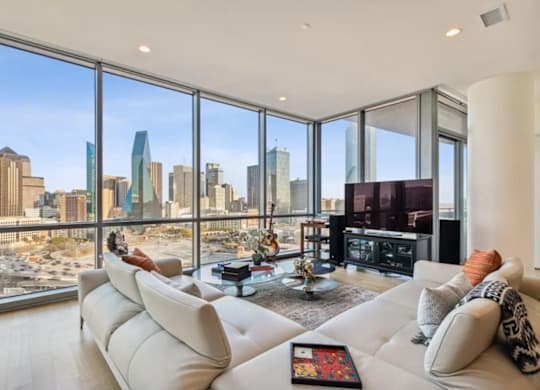 A living room with a view of the city skyline.