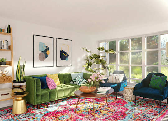 a living room with green furniture and a large rug