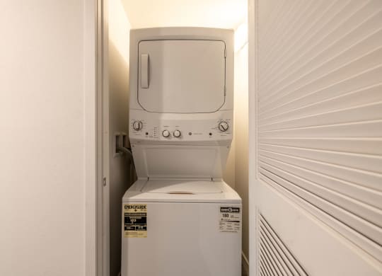 a white washer and dryer in a closet