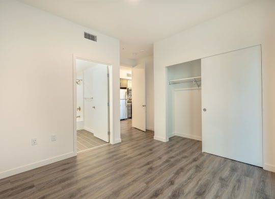 a renovated living room with white walls and wood floors