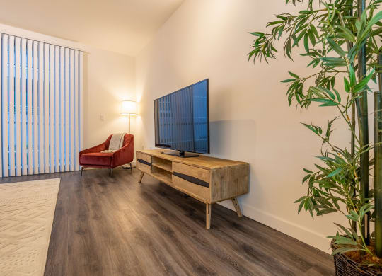 a living room with a couch and a tv on a wooden table