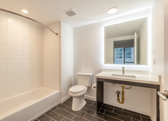 a bathroom with a toilet sink and a bath tub