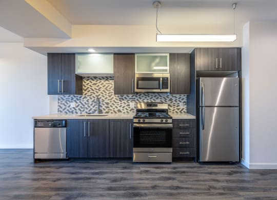 a kitchen with a stainless steel refrigerator and a microwave