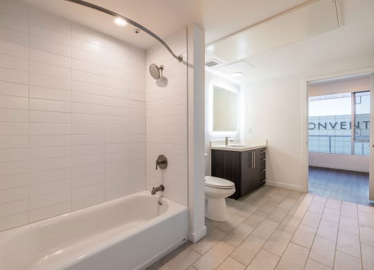 a bathroom with a tub and a toilet and a sink