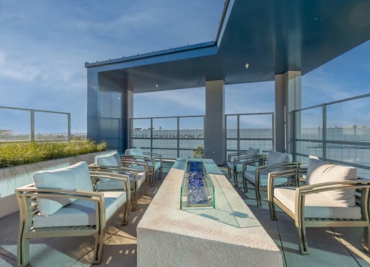a terrace with chairs and a table overlooking a river