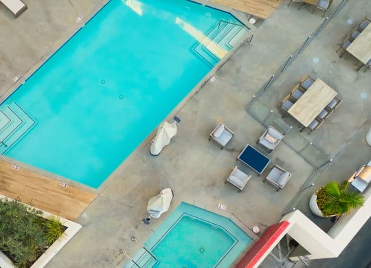 a view of the pool from above at a hotel with a blue pool
