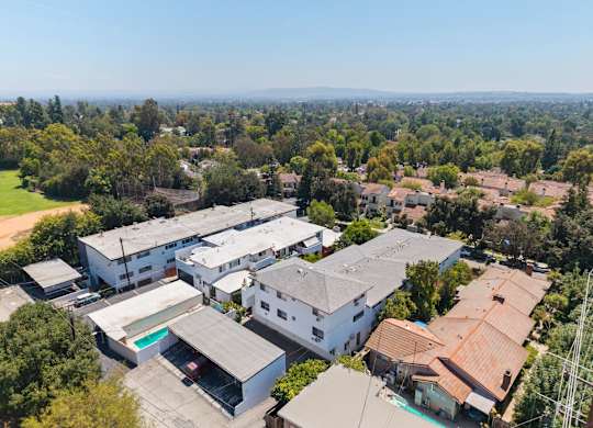A bird's eye view of a residential area with houses and trees.