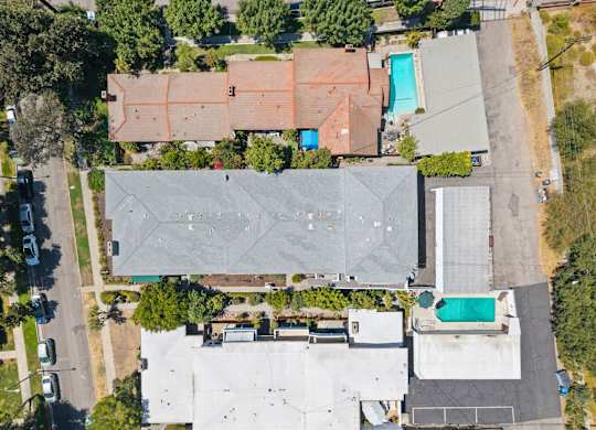 A large grey building with a pool in the middle of it.