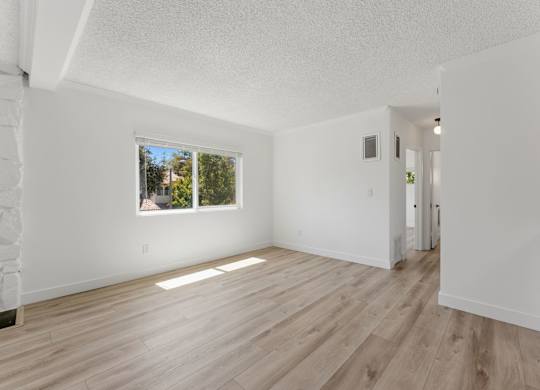 A room with wooden floors and white walls.