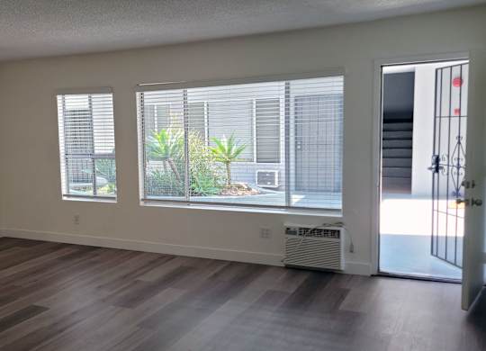A room with a window and a door.