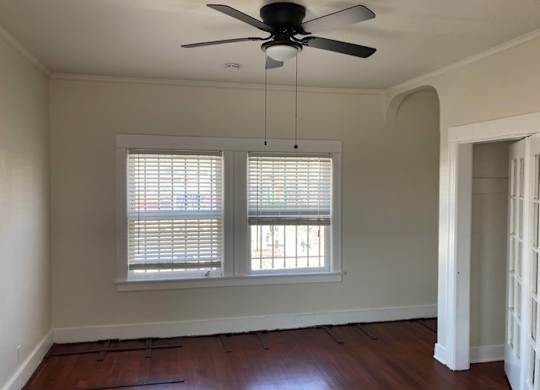 Studio apartment with great windows, ceiling fan, and old-style charm at The Western at Rosewood Apartments in Los Angeles, California.