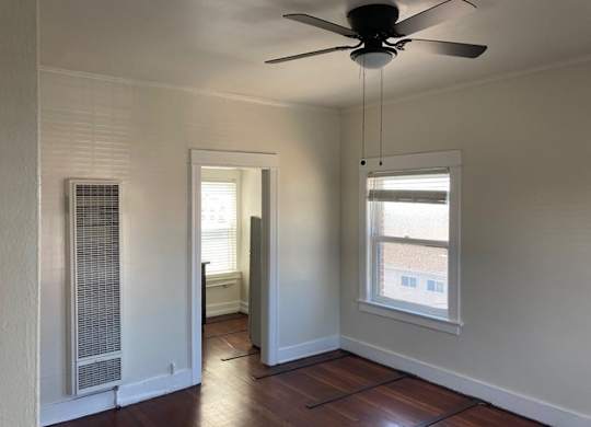 Studio apartment with beautiful hardwood floors, ceiling fan, and great natural light at The Western at Rosewood Apartments in Los Angeles, California.