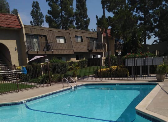 Large crystal clear swimming pool at Teton Pines Apartments in Escondido, California.