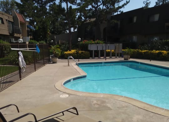 Swimming pool with beautiful surroundings at Teton Pines Apartments in Escondido, California.
