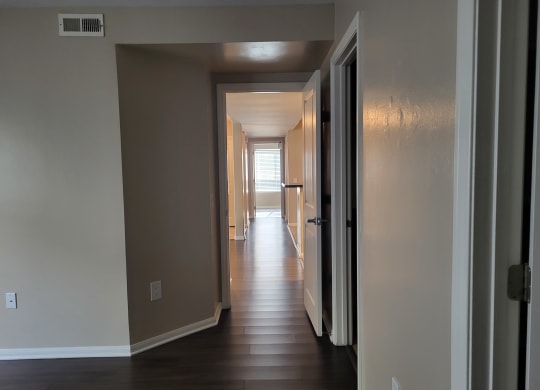 Master bedroom view down hallway to kitchen/living room area and on to bedroom hallway at The Cove at Bear Valley in Escondido, California.