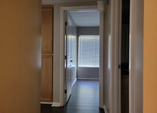 Bedroom hallway with built in cabinets and plank style flooring at The Cove at Bear Valley in Escondido, California.