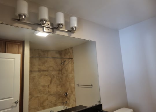 Bathroom with beautiful tile bath, large mirror and closets at The Cove at Bear Valley in Escondido, California.