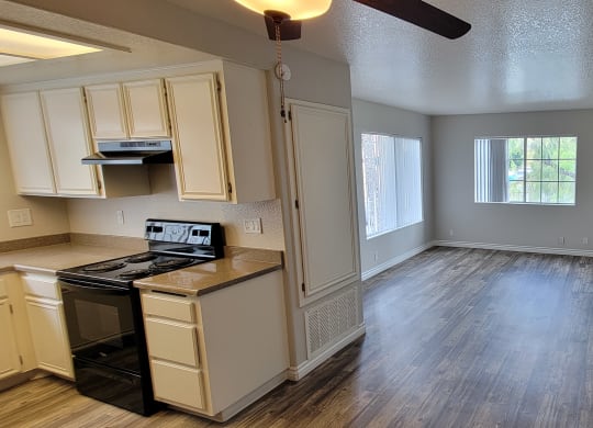 Kitchen and living room with hardwood floors at Lakeshore Terrace Apartments in Lakeside, California.
