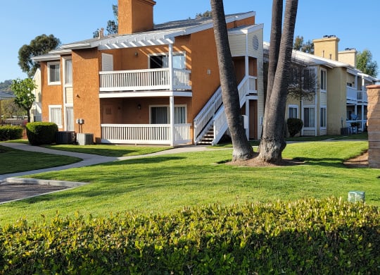 Sidewalk view of luxury apartments at The Cove at Bear Valley in Escondido, California.