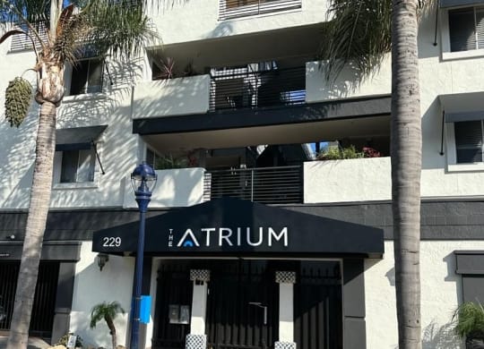 Sidewalk view of front enterance at the Atrium Apartments in downtown San Diego, CA.