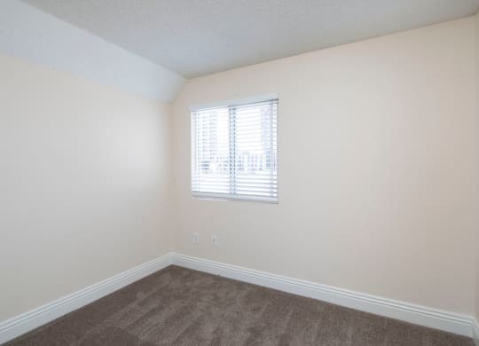 Carpeted bedroom at the Atrium Apartments in San Diego, California.