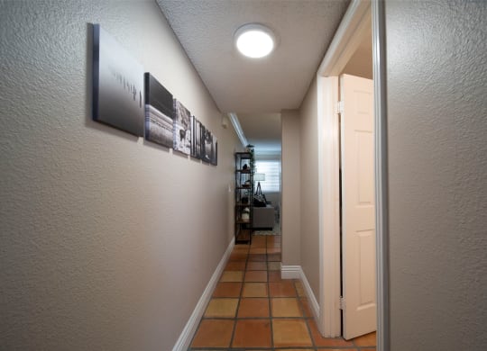 Model Unit showing Saltillo tiled flooring in bedroom hallway at the Atrium Apartments in San Diego, California.