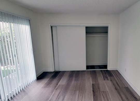 A room with a wooden floor and white walls.