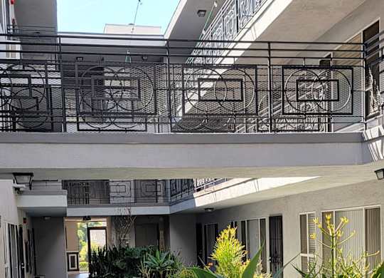 A modern building with a glass ceiling and a concrete floor.