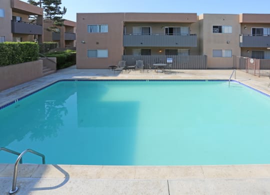 Swimming pool and sun deck at Villa Pacific Apartments in Oceanside, California.