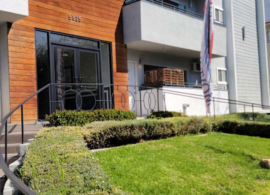 A modern building with a wooden facade and a glass door.