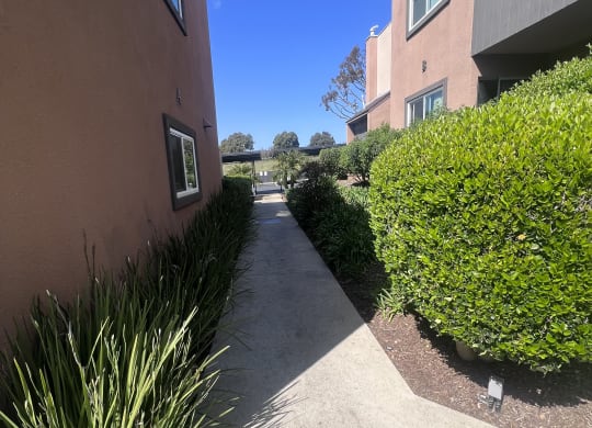 Walkway between apartment buildings at Villa Pacific Apartments in Oceanside, California.