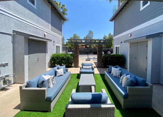 Community patio with couches at the Nines Townhomes in Escondido, California.