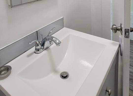 White sink with chrome plated fauset in bathroom at the Western At Rosewood apartments.