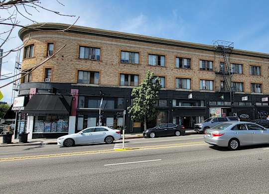Mid-day street view of the Western at Rosewood apartments in Los Angeles, California.