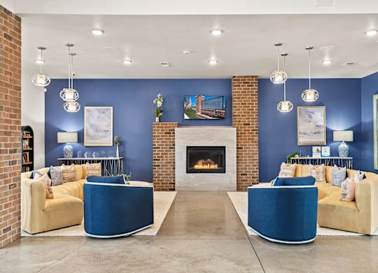 A living room with a fireplace and two yellow couches.