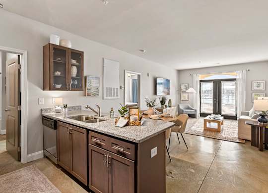 A modern kitchen with a large island and a dining area.