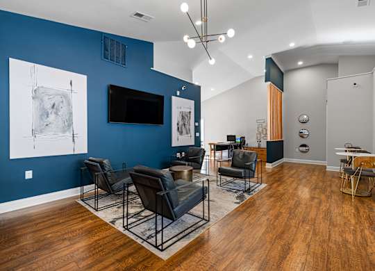 A living room with a blue wall and a television.