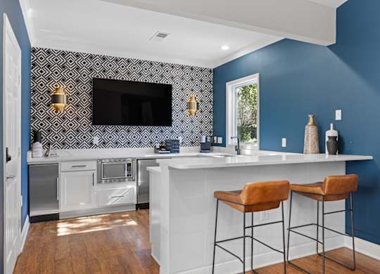 A kitchen with blue walls and white countertops.