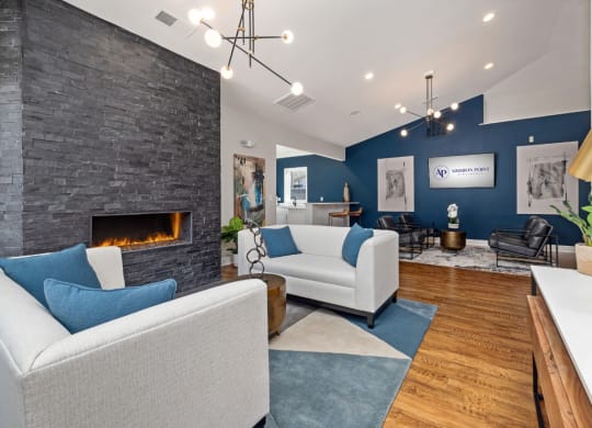 addison point interior resident lounge with blue and white furniture and a fireplace