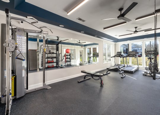 addison point interior resident gym with exercise equipment and a large window