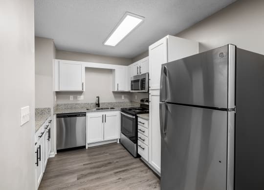 addison point interior home kitchen with stainless steel appliances and white cabinets