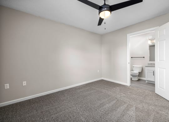 addison point interior home bedroom with a ceiling fan and a bathroom