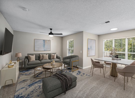 addison point interior staged model living room and dining room with a couch and a table