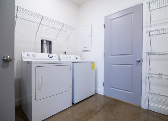 a laundry room with a washer and dryer and a door