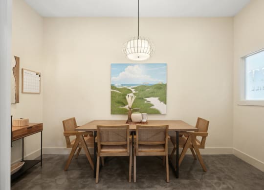 a dining room with a wooden table and chairs