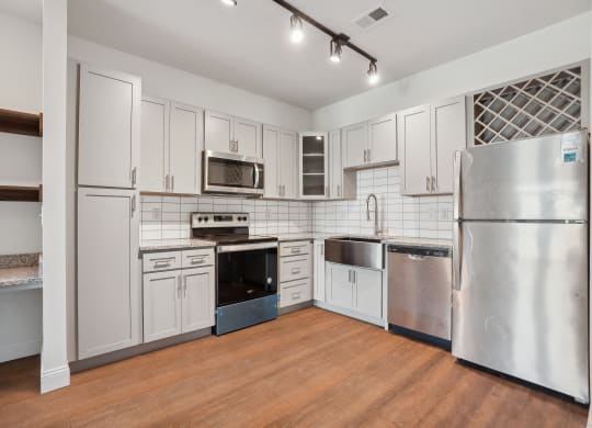 a kitchen with stainless steel appliances and white cabinets
