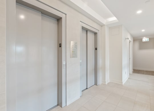 a row of elevators in a hallway of a building