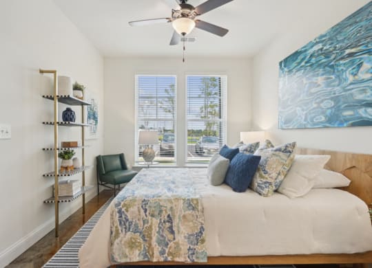 a bedroom with a bed and a ceiling fan